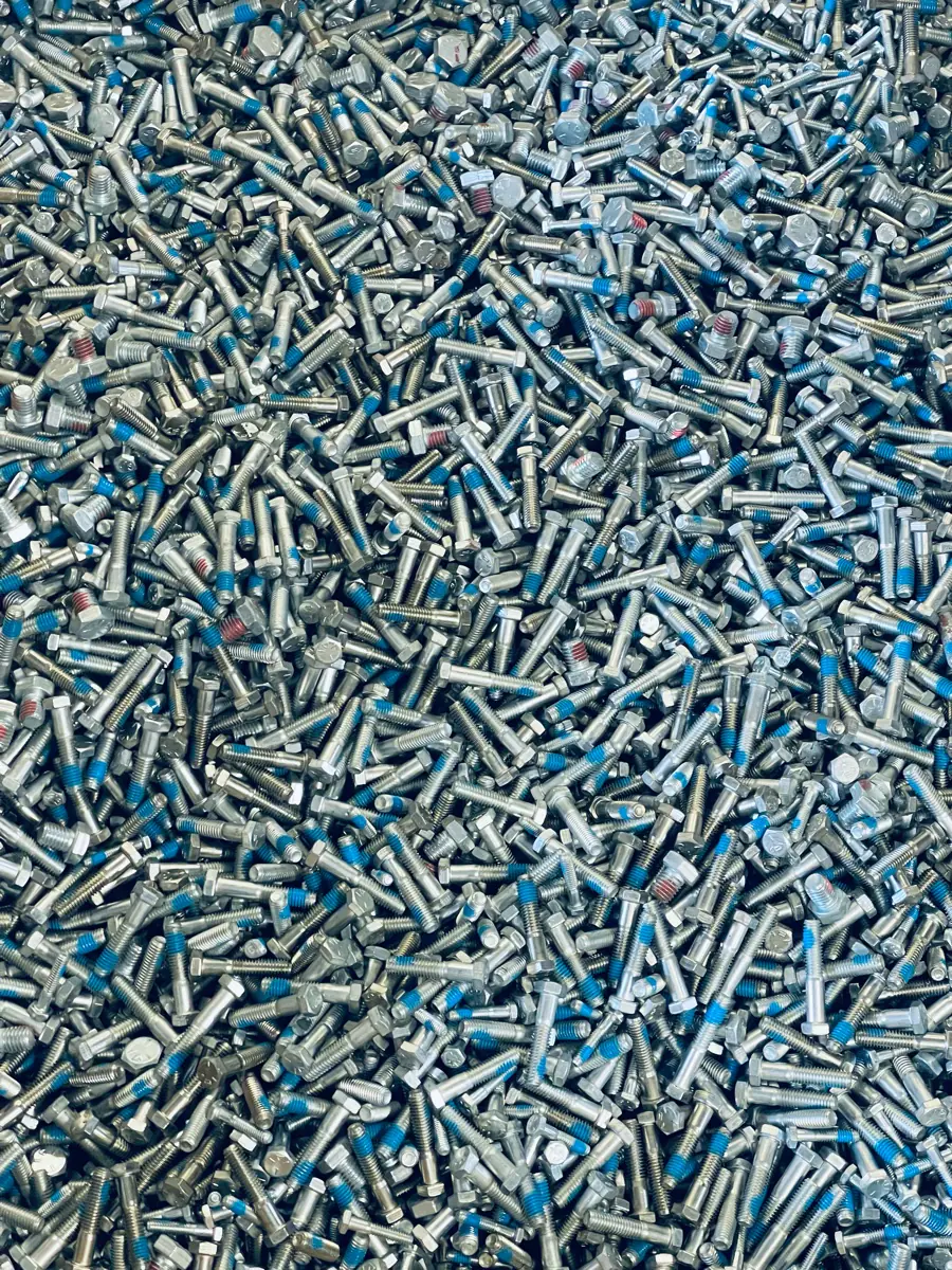 Industrial bolts with blue and red thread-locking patches
